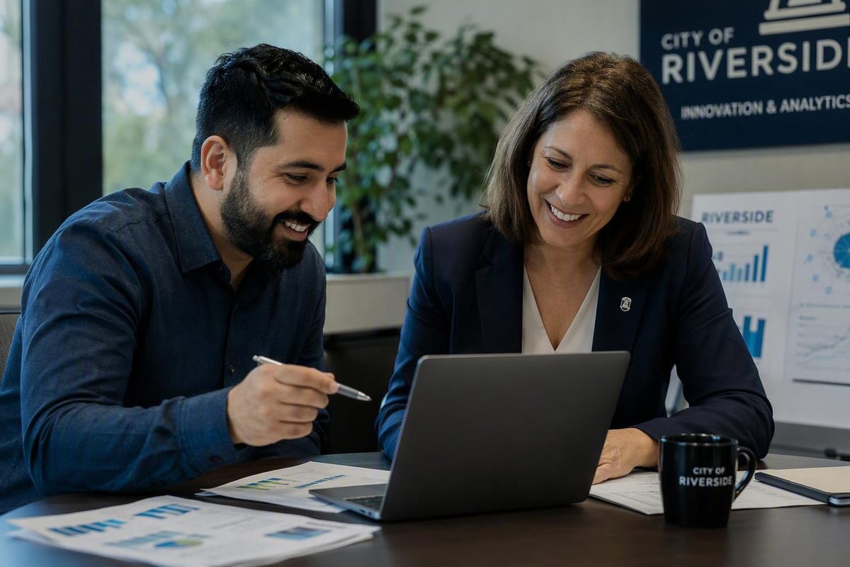 CivSaver analyst and city staff member reviewing findings together on a laptop